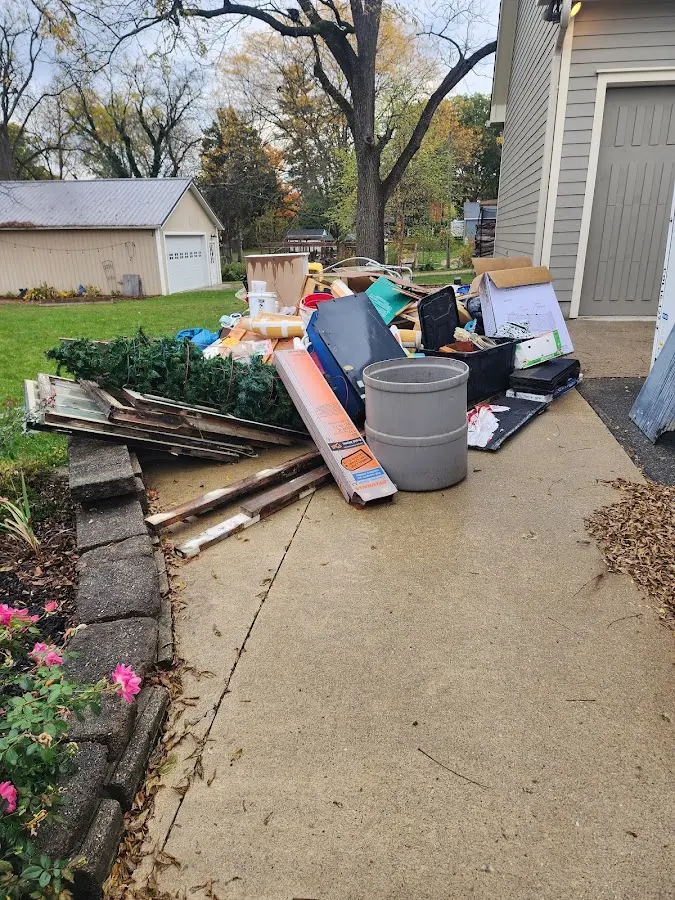 Dumpster being loaded with debris for 30 Yard Dumpster Rental in Bismarck